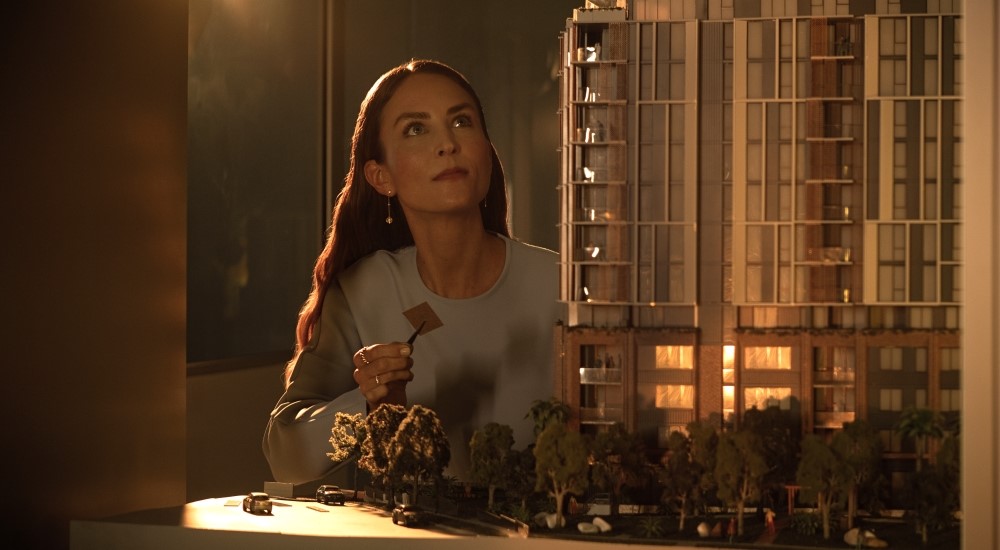 A female architect viewing building model
