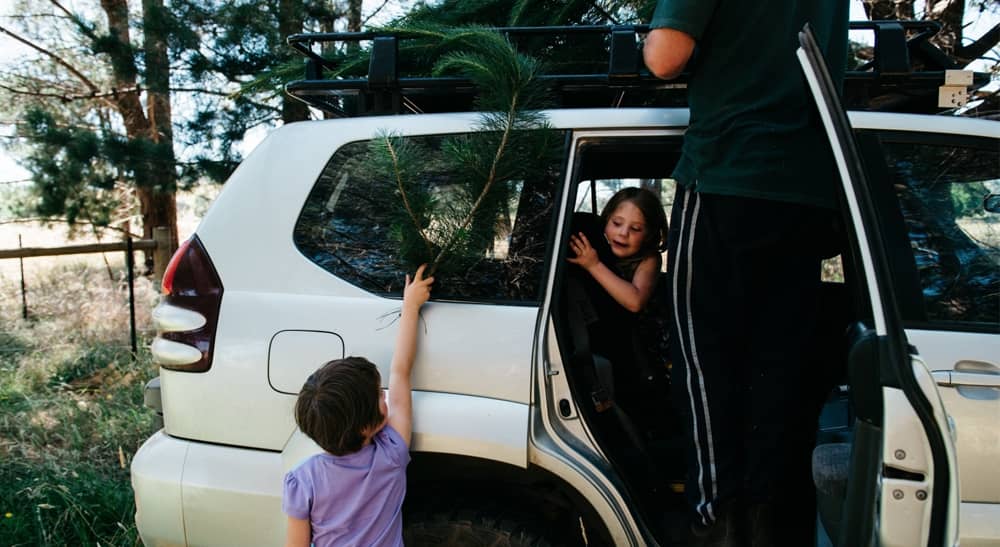 Car insurance claims family getting out of white 4WD
