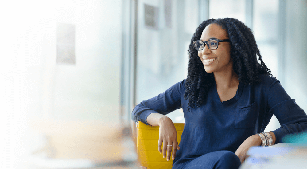 Portrait of woman sitting at desk in design office