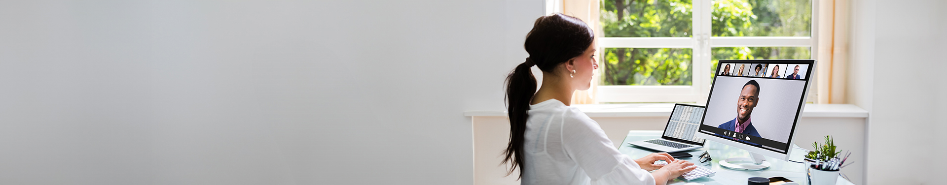 Businesswoman working from home meets with colleagues during virtual staff meeting