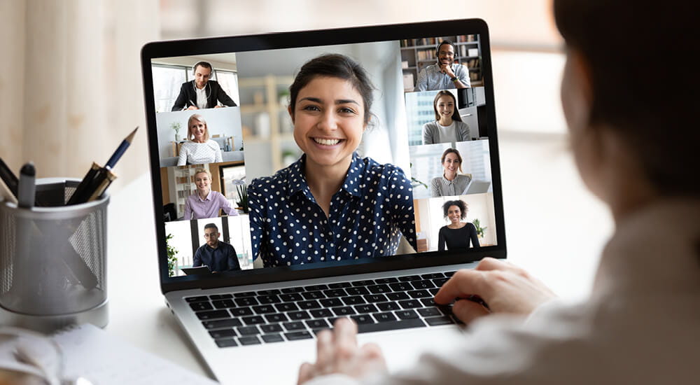 Businesswoman working from home meets with colleagues during virtual staff meeting