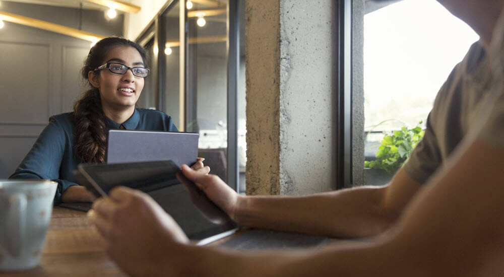 Businesswoman using digital tablet in modern open plan office