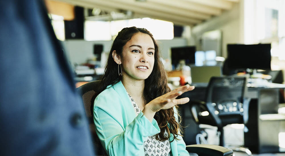 Businesswoman in discussion with coworkers in office