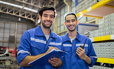 Warehouse worker talking on phone holding a clipboard