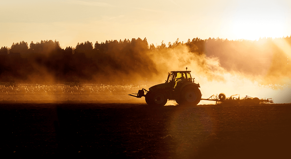Tractor cultivating field during summer