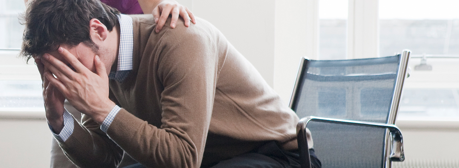 Man sitting with his head in his hands