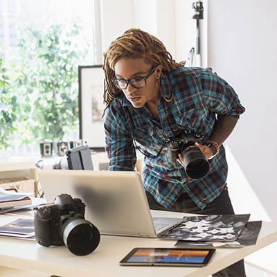 Male photographer using laptop computer
