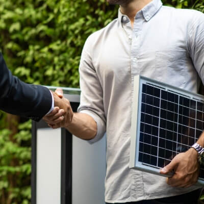 Businessman holding solar panel 