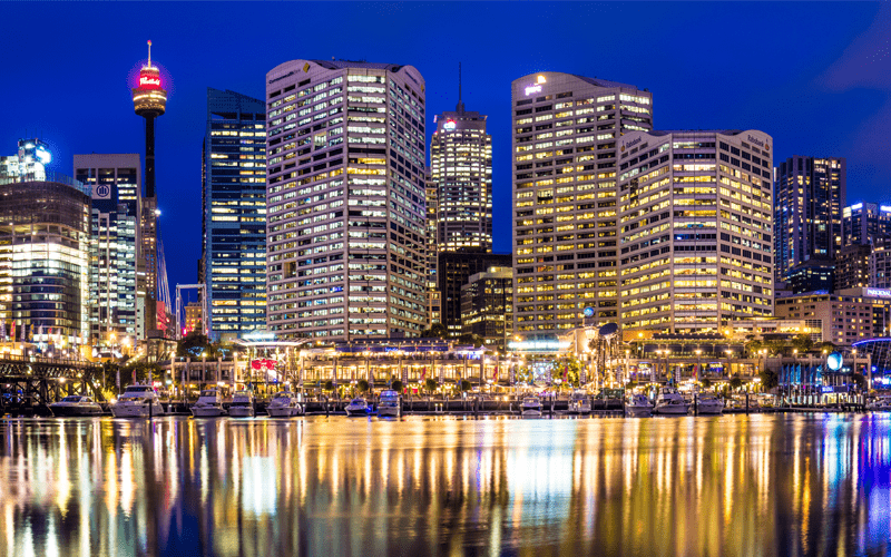 View of skyscraper buildings at night from Darling Harbour in Sydney, Australia