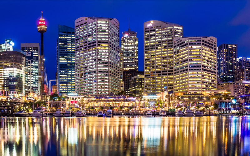 View of skyscraper buildings at night from Darling Harbour in Sydney, Australia