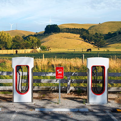 Two electric vehicle chargers in countryside