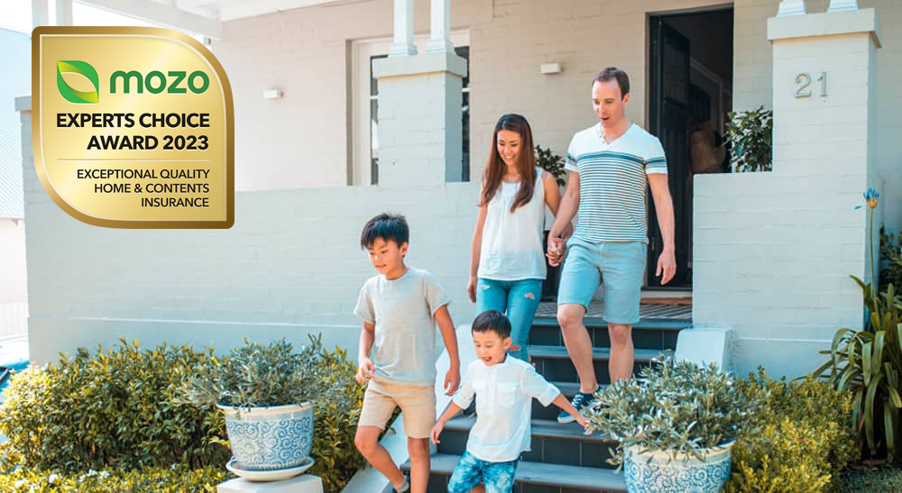 Family of four walking down the front steps of their home