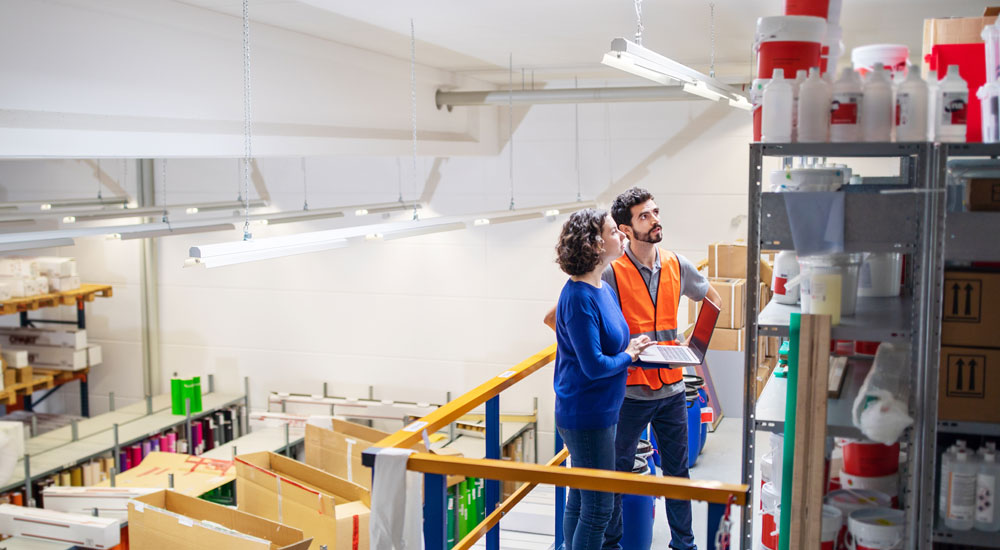 Liability quote info guide banner - Woman and man checking stock in a warehouse