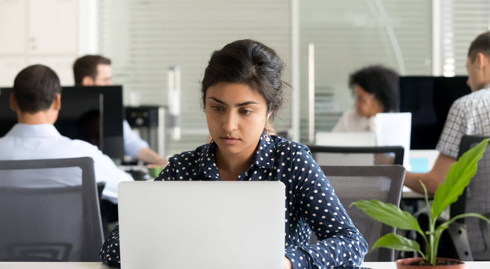 Young woman in the office completing online product and compliance training