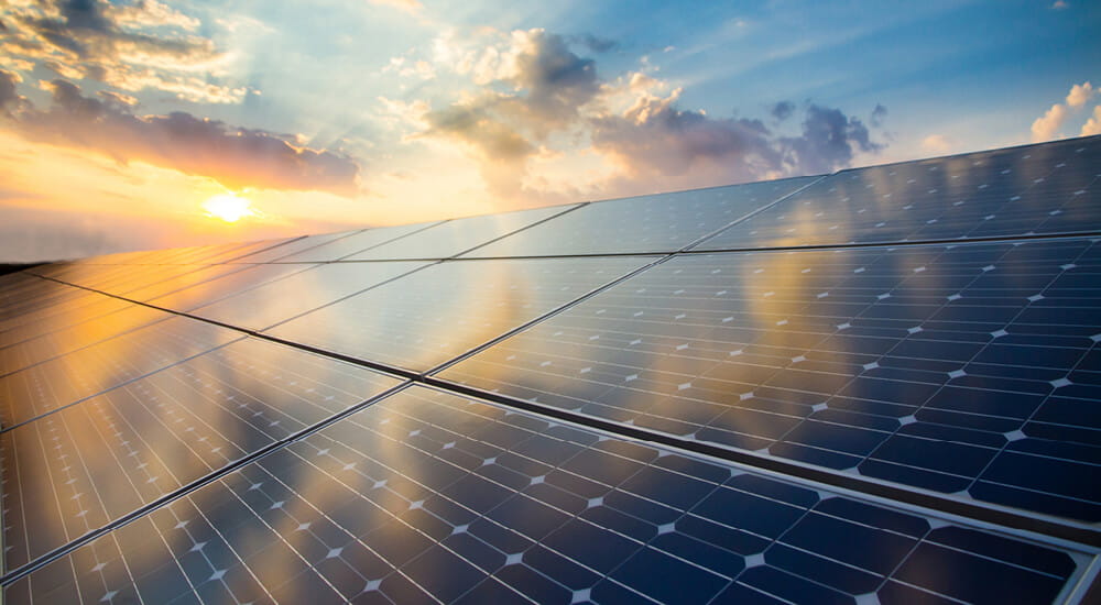 Sustainability - sun reflecting off solar panels