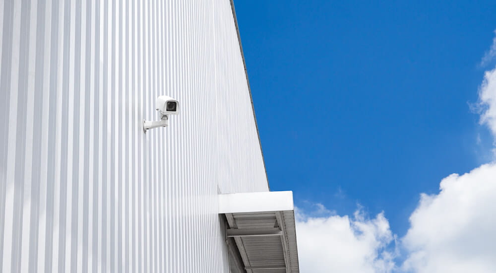 Security camera attached to the side of a commercial building