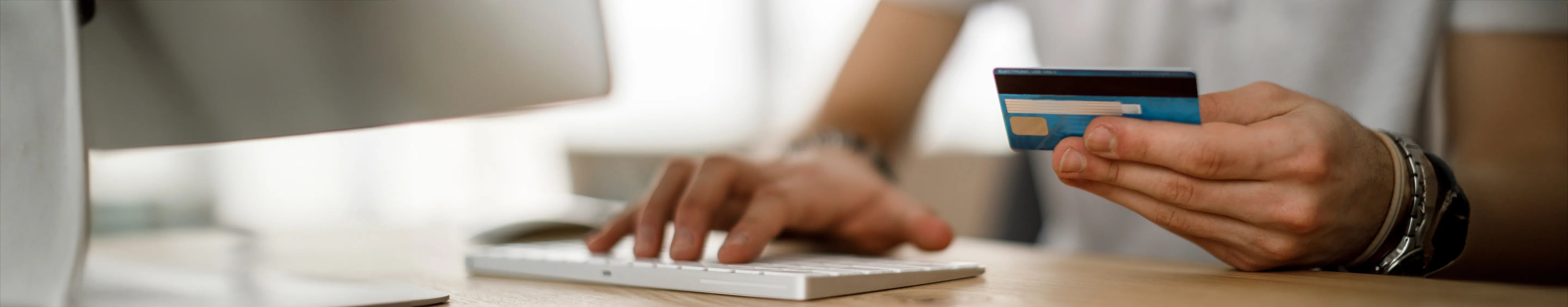Close up of male paying his bill online by credit card