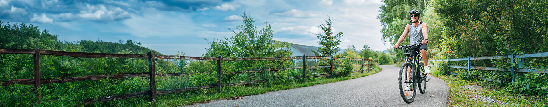 Single cyclist riding mountain road