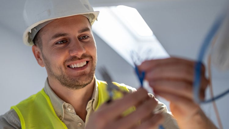 Male electrician looking at cable