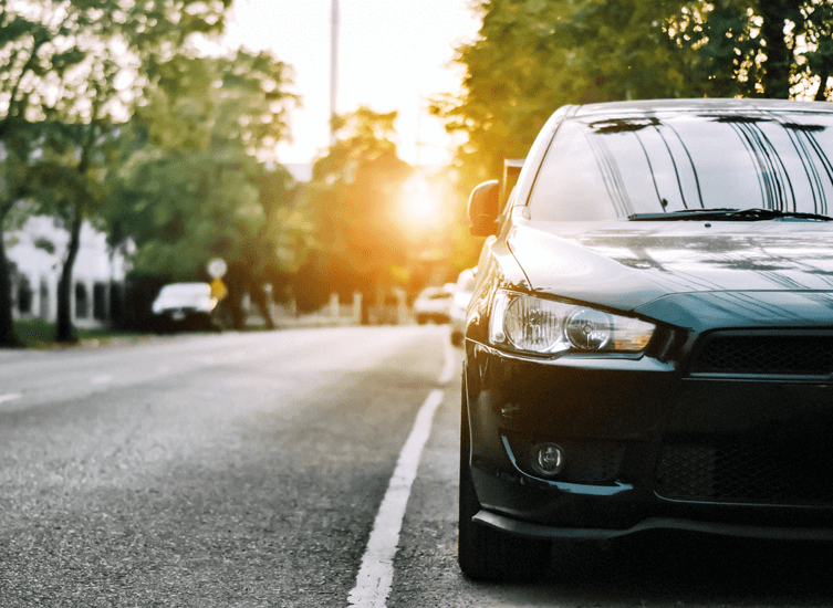 Ways to save on Comp car insurance text box over black car parked on street