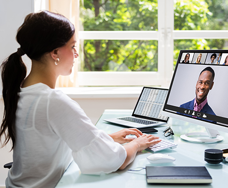 Businesswoman working from home meets with colleagues during virtual staff meeting