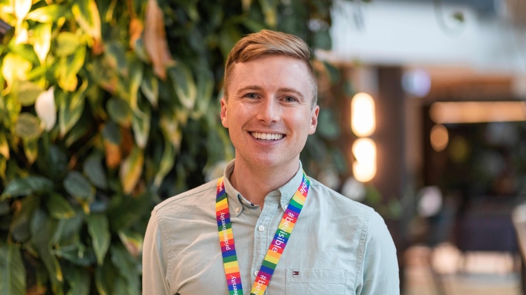 QBE graduate Liam smiling in Sydney office