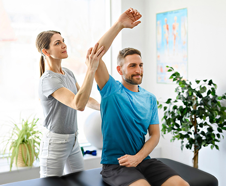 Rehabilitation physiotherapy worker with client