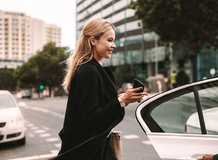Businesswoman getting into taxi