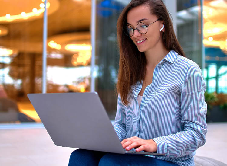 Modern happy casual smart businesswoman remotely working online at a computer