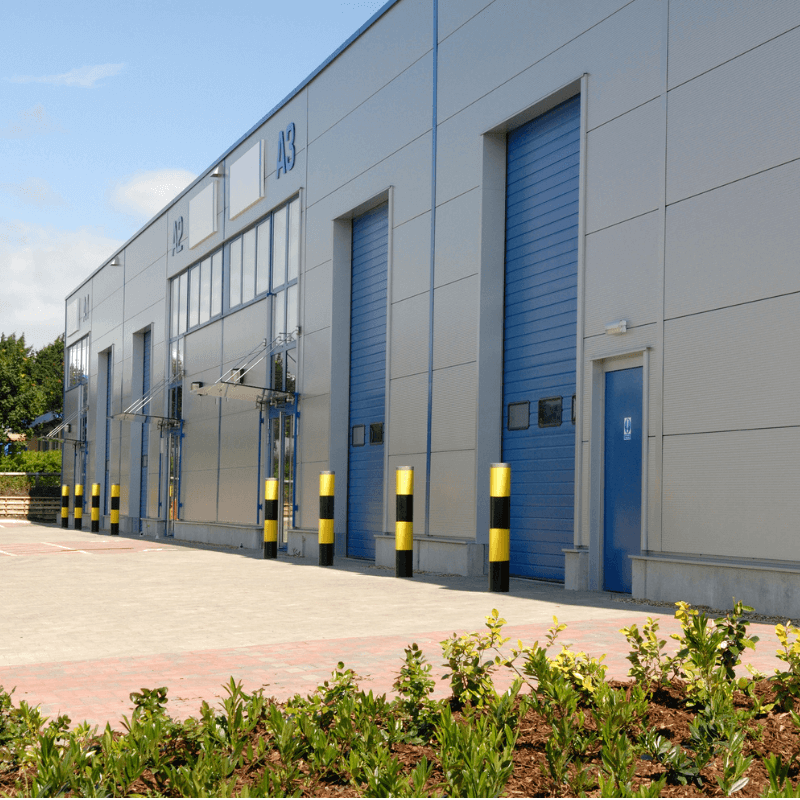 Exterior of a large distribution warehouse with gates for loading goods