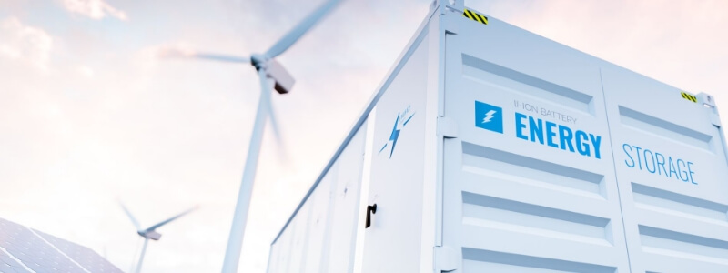 Conceptual image of a modern battery energy storage system with wind turbines in background