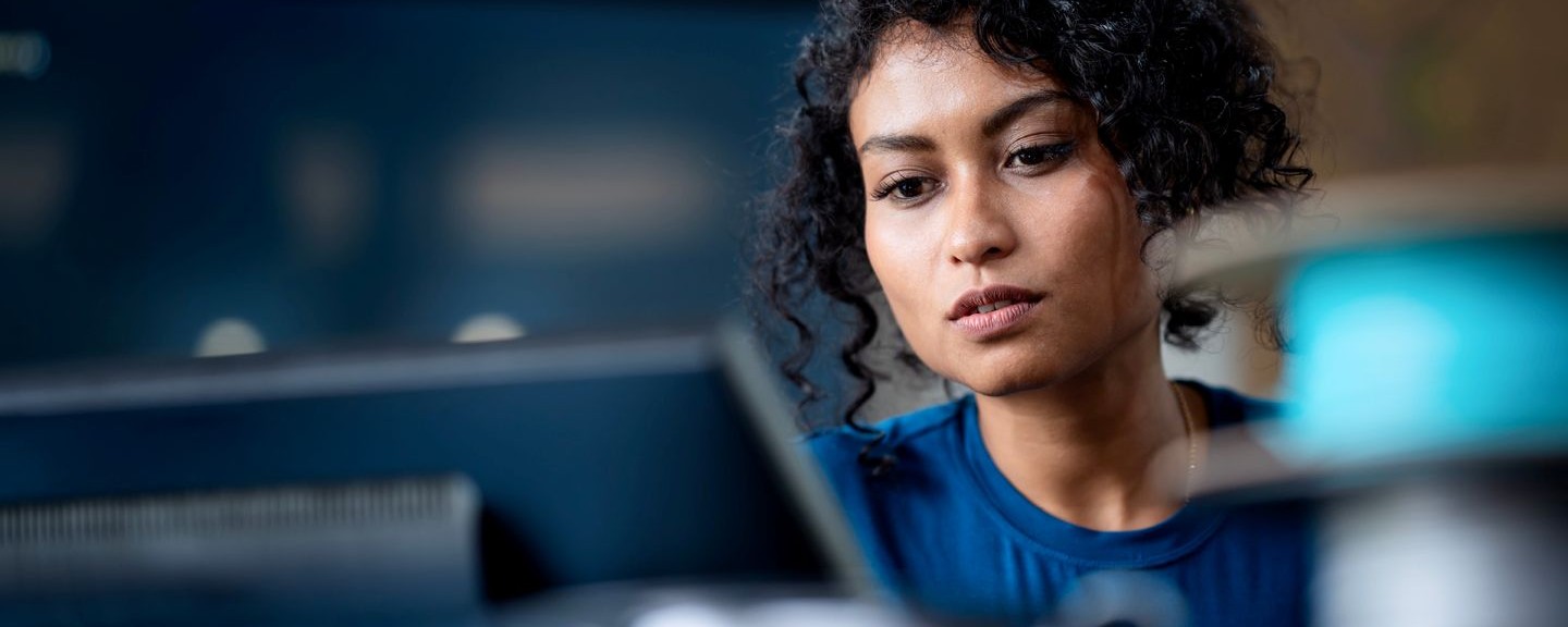 Headshot of woman looking at a laptop screen