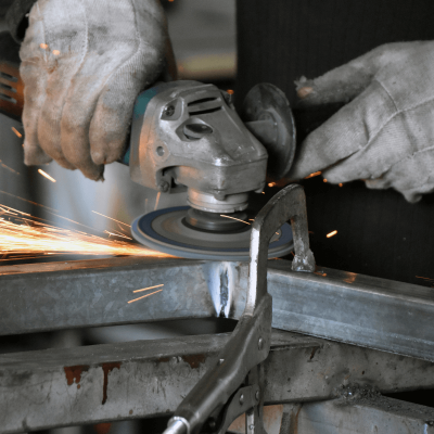 An industrial worker using an angle grinder