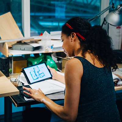 Woman sitting at her desk while looking at her laptop screen
