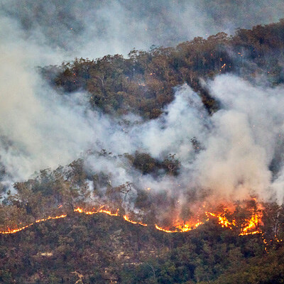 Aerial view showing line of bush fire and smoke