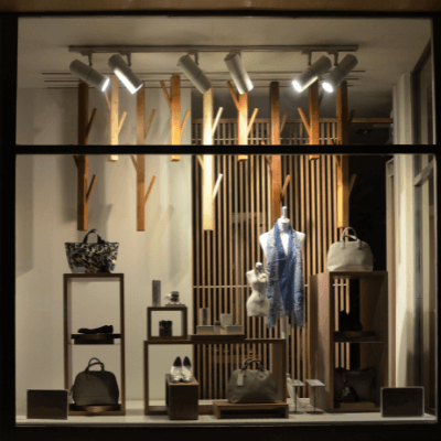 Clothing store window displaying shoes and other accessories