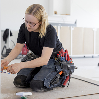 Female electrician working on the floor