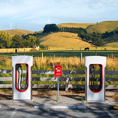 Two electric vehicle chargers in countryside