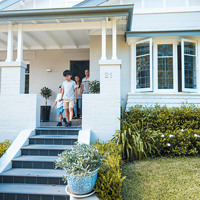 Family walking out of the front door of their home