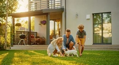 A family playing in the backyard of a suburban home