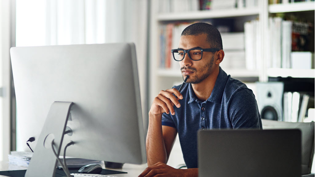 Sitting in front of a computer
