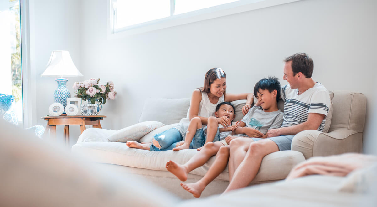 Young family sitting together in their home