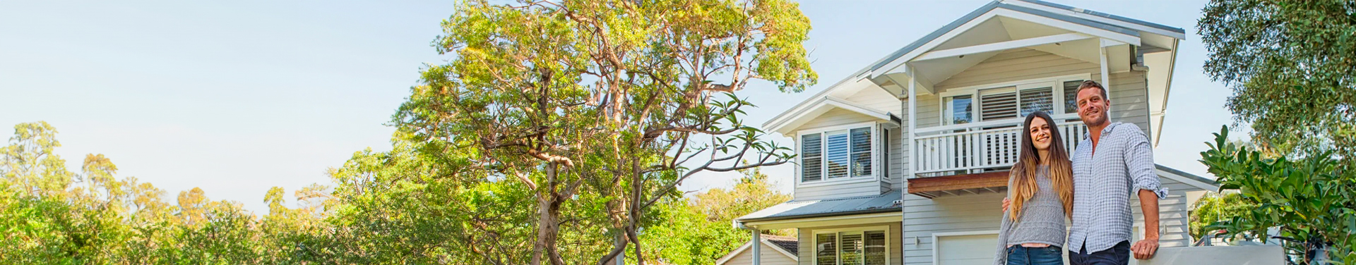 Homeowners standing outside their house