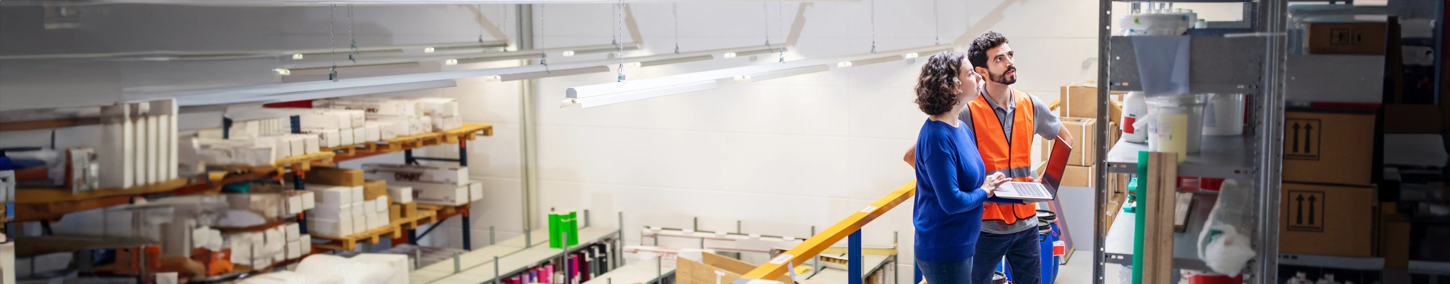 Liability quote info guide banner - Woman and man checking stock in a warehouse