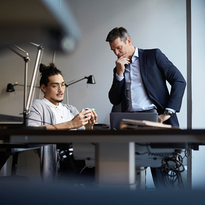 Two male corporate workers in discussion