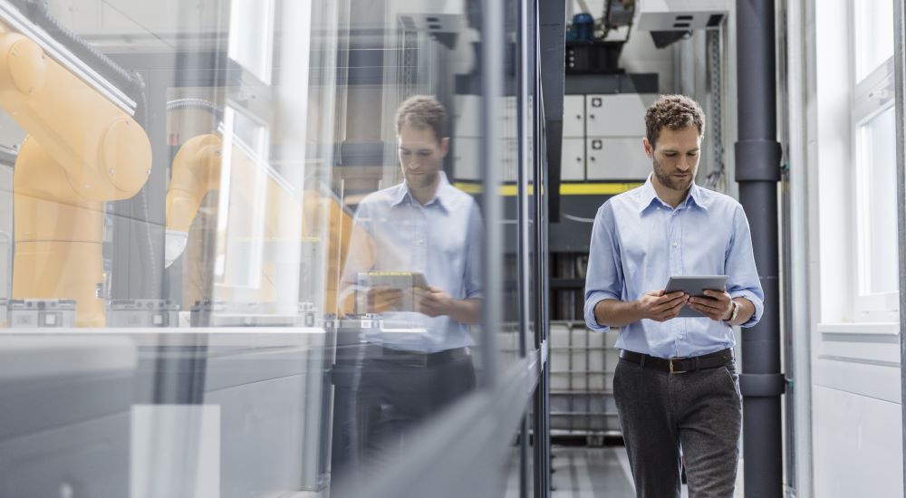 Professional man walking through an industrial building