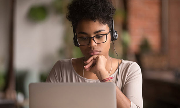 Woman sitting at her laptop viewing a training course
