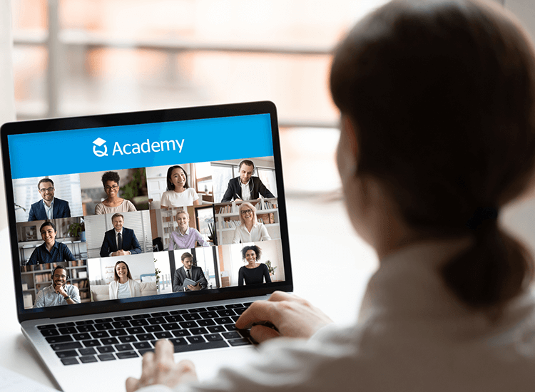 Back view of a man attending a QBE Q Academy virtual online training course on his laptop