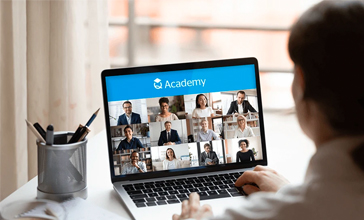 Back view of a man attending a QBE Q Academy virtual online training course on his laptop