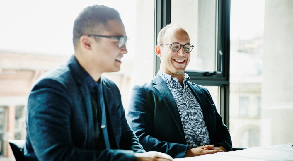 Two businessmen seated together at a table